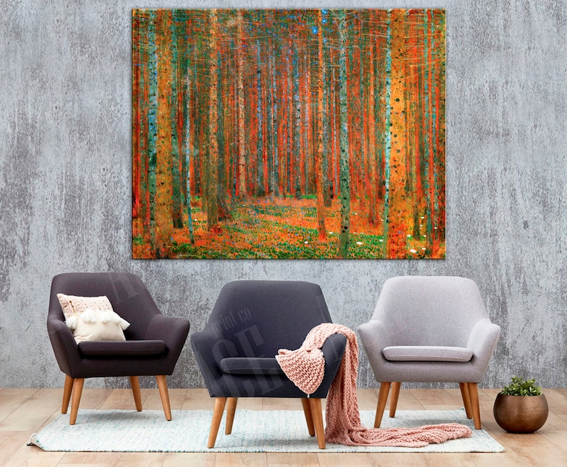 May include: Three armchairs in a living room setting with a large abstract painting of a forest in the background. The armchairs are in different colors: dark gray, light gray, and dark gray with a pink throw blanket. The painting is a vibrant mix of orange, yellow, and green.