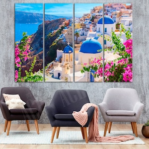 May include: A three-panel canvas print depicting a picturesque view of a white-washed village with blue domed buildings, nestled on a cliff overlooking a turquoise sea. Lush greenery and vibrant pink flowers add a touch of color to the scene.