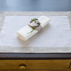 Classic white linen placemat with flower pattern border. Place mat with design, classic style linen placemat.