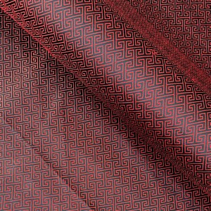 May include: Close-up of a fabric with a repeating geometric pattern in red and black. The pattern consists of interlocking Greek key designs, creating a textured appearance. The fabric is folded, showing depth and dimension.