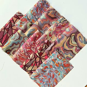 May include: A collection of fabric swatches featuring various woven patterns including geometric lines, abstract swirls, and animal-inspired prints in vibrant shades of magenta, turquoise, orange, purple, and gold with visible frayed edges.