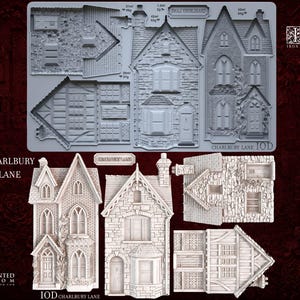 May include: A light gray silicone mold featuring architectural elements for creating miniature houses, labeled Charlbury Lane and Iron Orchid Designs 2026 Holiday Collection. The mold includes detailed textures for stone walls, roofs, windows, and doors.