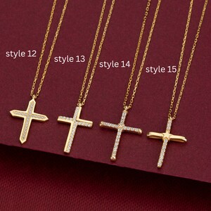 May include: Four gold necklaces with different styles of diamond cross pendants. The necklaces are labeled "style 12", "style 13", "style 14", and "style 15".