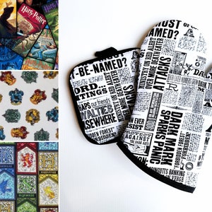May include: A white oven mitt and pot holder set with a black border. The set features a newspaper print design with text like "Dark Mark" and "Ministry on Red Alert". The image also shows fabric with Harry Potter book covers and house crests.
