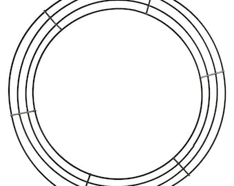 May include: A black metal wreath frame with four concentric rings. The frame is circular and has several metal supports connecting the rings. The background is plain white.