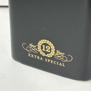 May include: Black bottle with gold lettering that reads "Aged 12 Years Extra Special".