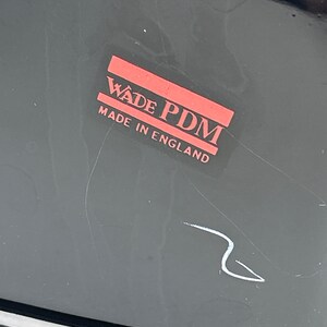 May include: A black and red label with the text "Wade PDM Made in England".