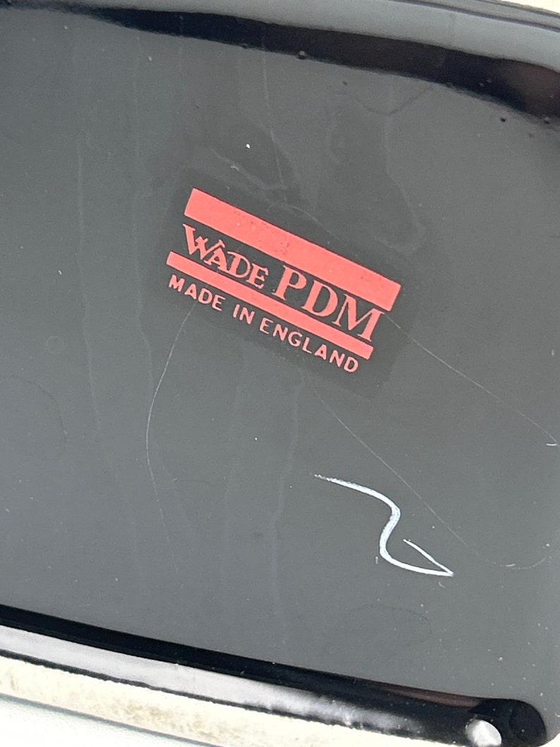 May include: A black and red label with the text "Wade PDM Made in England".
