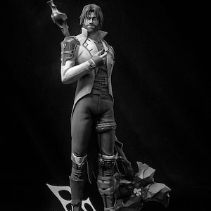 May include: A black and white figurine of a man wearing a long coat and holding a staff. He is standing on a rocky base with plants growing around it.