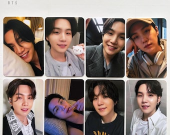 May include: A collection of eight rectangular photo cards featuring images of a person with dark hair. The cards showcase various poses and expressions, with some featuring the person smiling and wearing different outfits. The BTS logo is in the top left corner.