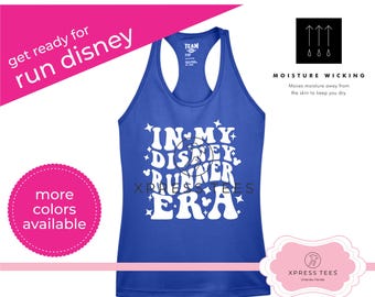 May include: A royal blue tank top with a white graphic that says "In My Disney Runner Era". The tank top is moisture wicking and has a white racerback.