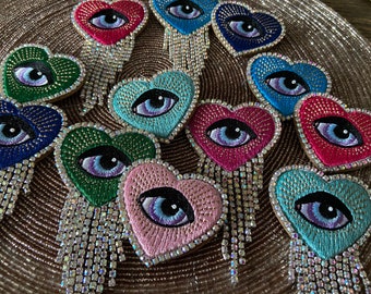 Embroidered brooch “Heart Eye” with crystal clear rhinestone fringes in seven different colors