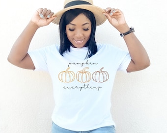 May include: White t-shirt with a graphic of three pumpkins and the text "pumpkin everything".