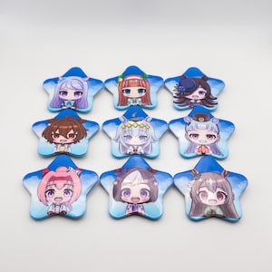 May include: A set of nine star-shaped pinback buttons arranged in a grid. Each button features a unique chibi-style anime character illustration set against a blue sky background with white clouds. The characters have varied hair colors and styles.