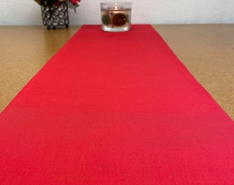 May include: A red table runner, perfect for adding a festive touch to your dining table.