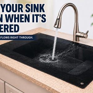 May include: A black sink cover with the text "USE YOUR SINK EVEN WHEN IT'S COVERED" and "WATER FLOWS RIGHT THROUGH." A silver faucet is running water into the sink. The sink is on a beige countertop.