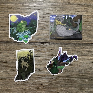 May include: Four sticker designs featuring different states in the United States. The first sticker is a green frog in a pond with a moon and stars in the background. The second sticker is a whale swimming in a lake with mountains in the background. The third sticker is a mermaid with long green hair and a tail. The fourth sticker is a person in a green cloak with a black creature in the background.