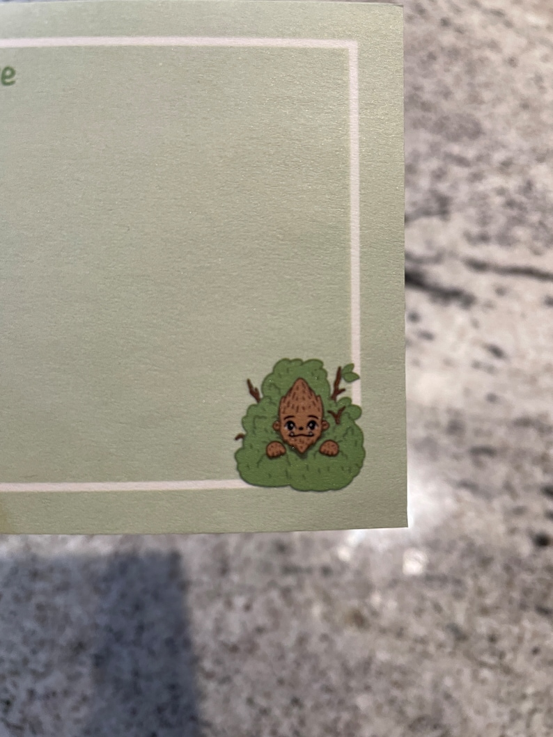 May include: A cartoon illustration of a brown creature with a surprised expression peeking out from behind green foliage.
