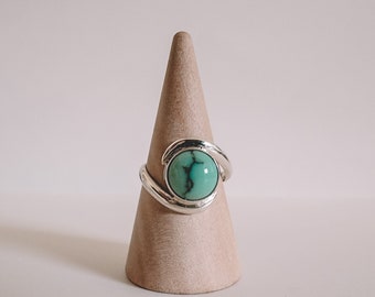 Anel turquesa com detalhe em espiral, feito por artesãos.
