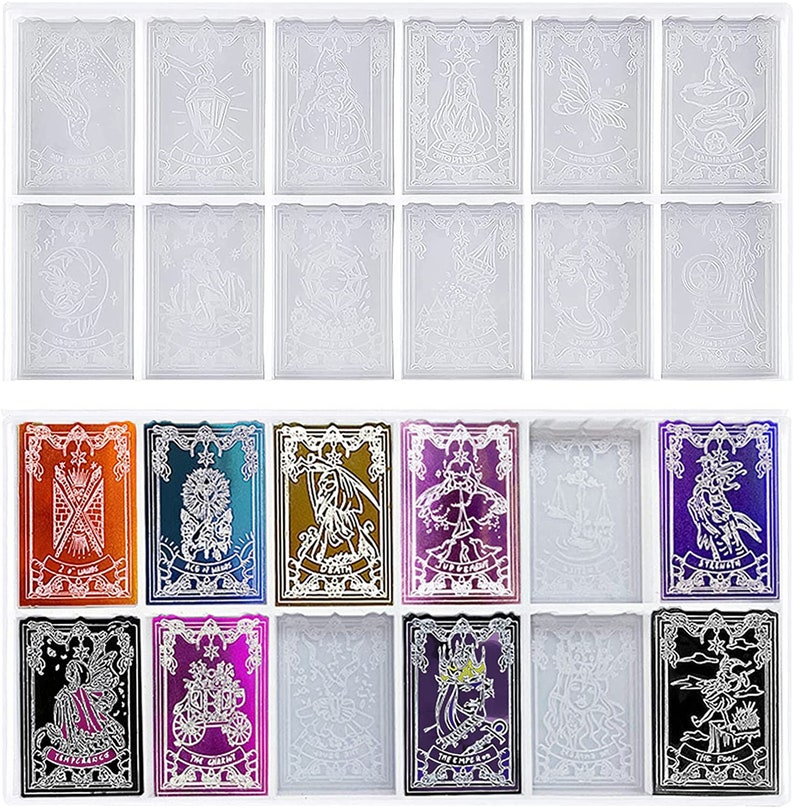 May include: A collection of tarot card molds in a clear tray. The molds feature intricate designs of various figures and symbols. Some cards have metallic foil accents in colors like orange, blue, and purple. The cards are rectangular with decorative borders.