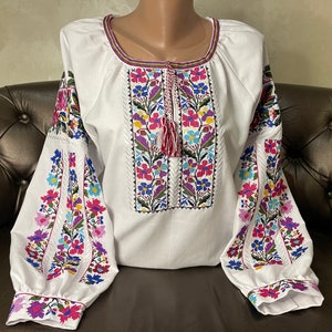 Ukrainian designer cotton vyshyvanka blouse for women. White peasant embroidered blouse with cross-stitched flowers.