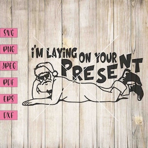May include: A black and white illustration of Santa Claus laying on his stomach with the text "I'm laying on your present".