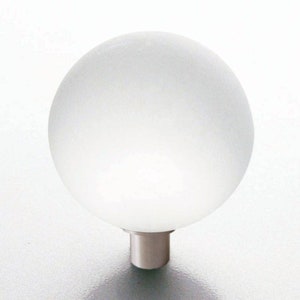 May include: A frosted glass cabinet knob with a silver metal base.