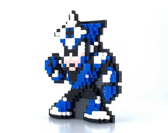 May include: A blue and white pixelated figure with a black helmet and a white stripe. The figure is standing with its arms raised and fists clenched.