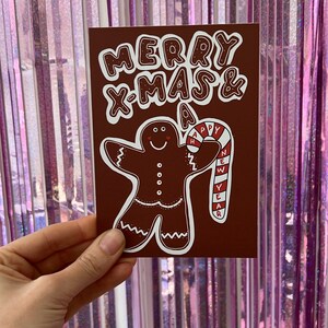 Weihnachts-Postkarte "Merry Christmas & happy new year" - Grußkarte zu Weihnachten mit Lebkuchenfigur und Zuckerstange - bunt, verspielt