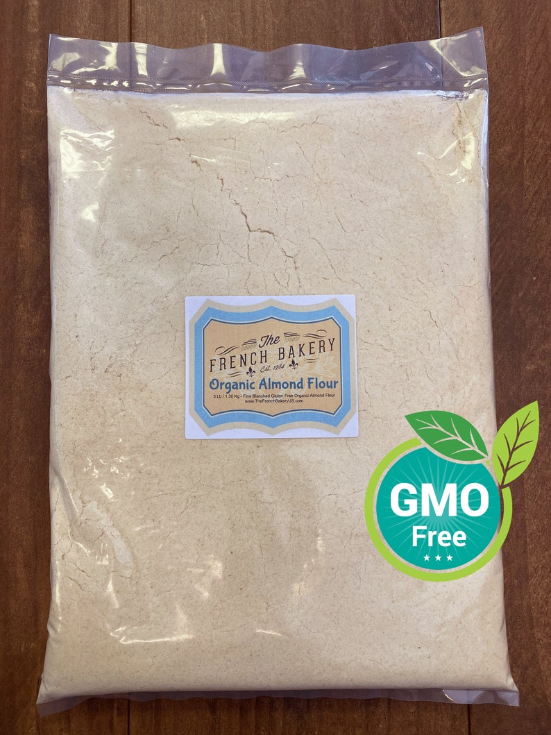 May include: A white bag of The French Bakery brand organic almond flour. The bag is sealed and has a label that says "The French Bakery" and "Organic Almond Flour". The bag also has a green and white sticker that says "GMO Free".