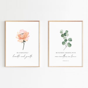 May include: Two printable wall art prints with watercolor floral designs. The first print features a peach-colored flower with the text "BE COMPLETELY humble and gentle". The second print features a green eucalyptus branch with the text "BE PATIENT, BEARING WITH one another in love EPHESIANS 4:2".
