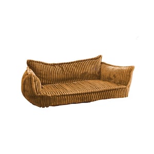 Op de afbeelding: Een bruin corduroy hondenbed met een verhoogde rand en een bolster aan één kant. Het bed is ontworpen om comfort en ondersteuning te bieden aan huisdieren.