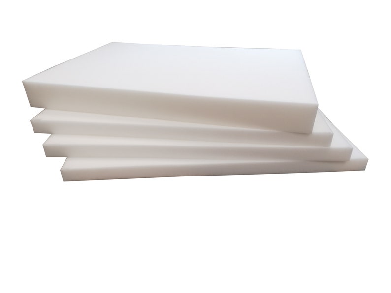 May include: A stack of four white foam sheets, each rectangular and of varying thicknesses. The foam appears clean and smooth, with a bright, neutral color. The sheets are neatly arranged, suggesting a product for padding or insulation.