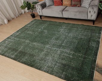 May include: A green vintage rug with a faded, distressed pattern. The rug is rectangular and made from a soft, woven material.