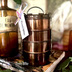Beautiful tiffin lunchbox. 
metal tiffin box. 
lunch dabba. 
compartment lunchbox 
South Asian Lunch Tin