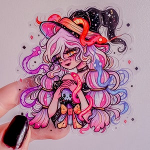 May include: A colorful illustration of a witch with long pink and purple hair wearing a black and white hat with stars. She is holding a skull and surrounded by snakes.