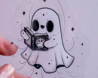 May include: A black and white illustration of a ghost reading a book with a spooky ghost on the cover. The ghost is surrounded by small stars.