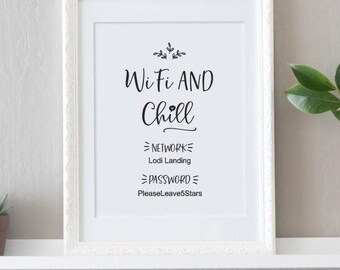 May include: A white framed sign with the text "Wi-Fi AND Chill" and the network name and password listed below. The sign is on a white shelf with a small potted plant and a vase of pink flowers.