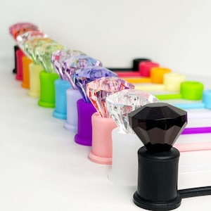 Diamond-shaped straw topper for Stanley cup, clear silicone accessory with sparkle detail.