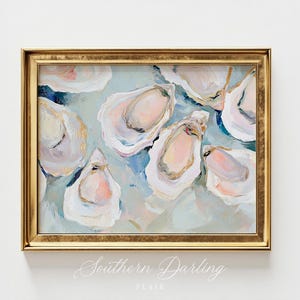 May include: A painting of oyster shells in shades of pink, white, and blue on a light blue background. The painting is framed in a gold frame.
