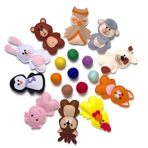 May include: A set of felt animal finger puppets, including a bear, owl, sheep, rabbit, penguin, pig, squirrel, chicken, cat, and dog. The puppets are arranged in a circle around a set of colourful felt balls.