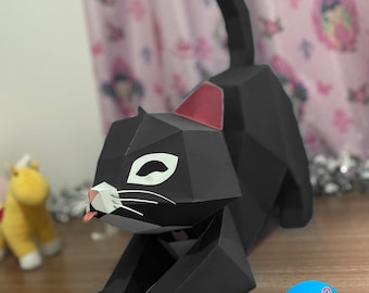 May include: A black papercraft cat with white markings on its face and tail, sitting on a wooden surface. The cat is in a stretching pose with its tongue sticking out. The cat is made of folded paper and has a 3D effect. The image includes the text "chen paper" in a blue circle with scissors.