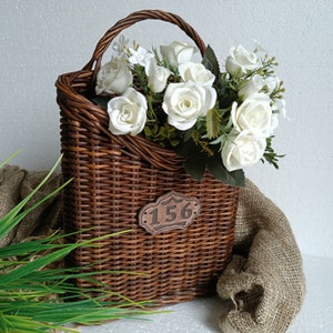 A rustic-style hanging door basket, crafted from woven brown fabric, is perfect for adding a decorative touch to your walls or doors