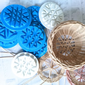 May include: A set of blue and white snowflake-shaped silicone molds, a wicker basket, and two smaller wicker baskets. The blue molds are stacked on top of each other.