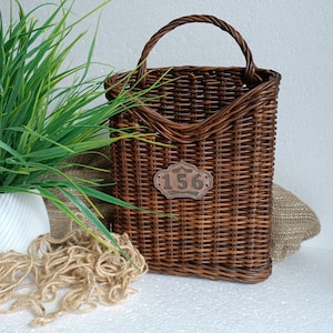 A hanging door basket in a rustic style made of woven brown fabric is ideal for decorating walls or doors in the house