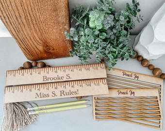 May include: Two wooden rulers with the text "Brooke S." and "Miss S. Rules!"  Two wooden pencil jigs with the text "Pencil Jig".