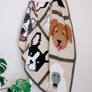 Corner to corner dog breed throw blanket draped on a white stair by the wall.