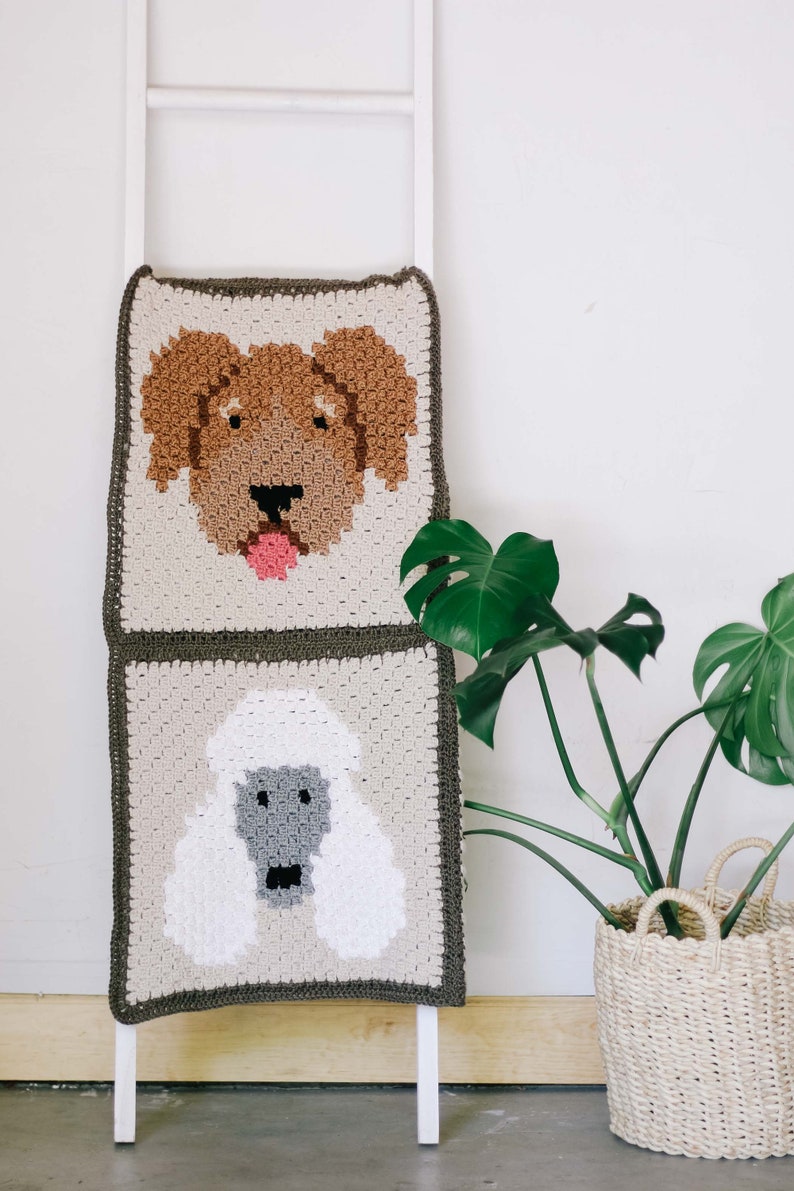 A golden doodle and poodle portrait dog blanket draped on a white stair.