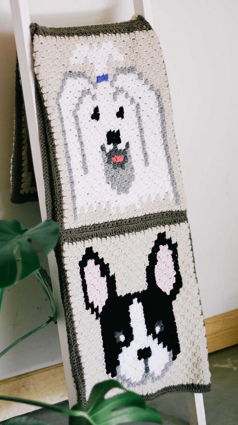 A Yorkie and Boston terrier design blanket as a gift for a dog lover draped on a wooden stair.