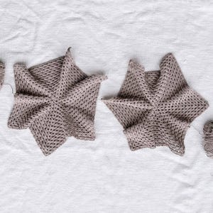 Two in-progress hexagons with yarns attached to them.